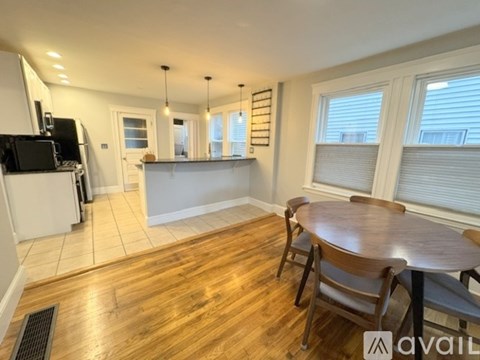 A kitchen with a dining table and chairs is available for rent.