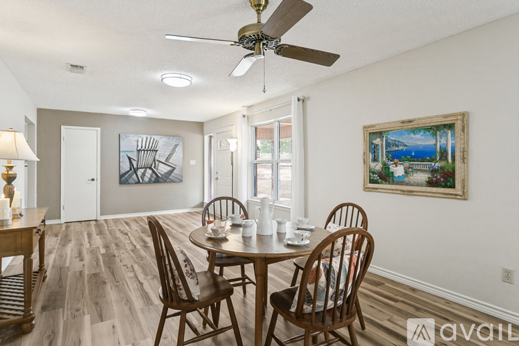 A dining room with a wooden table and chairs.