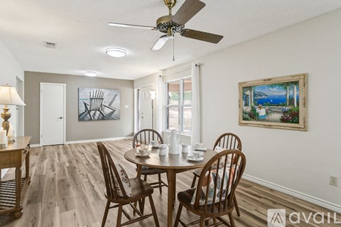 A dining room with a wooden table and chairs.