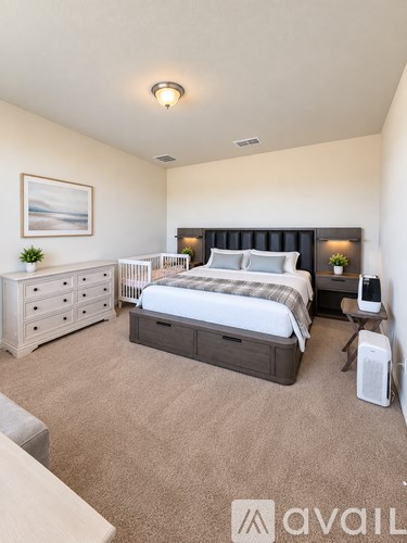 A bedroom with a large bed, a dresser, and a nightstand.
