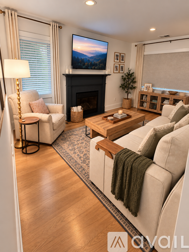 A living room with a fireplace and a television on the wall.