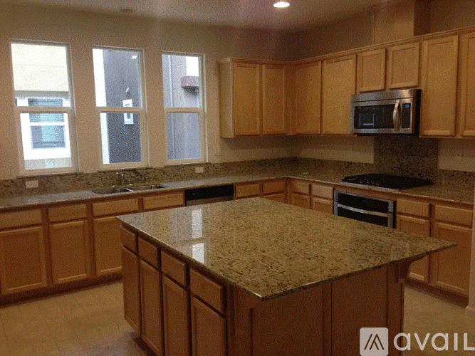 A kitchen with wooden cabinets and granite countertops.