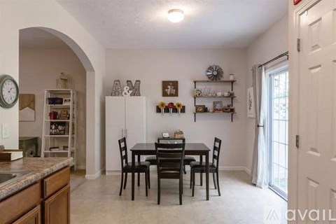 A kitchen with a table and chairs in the middle of the room.