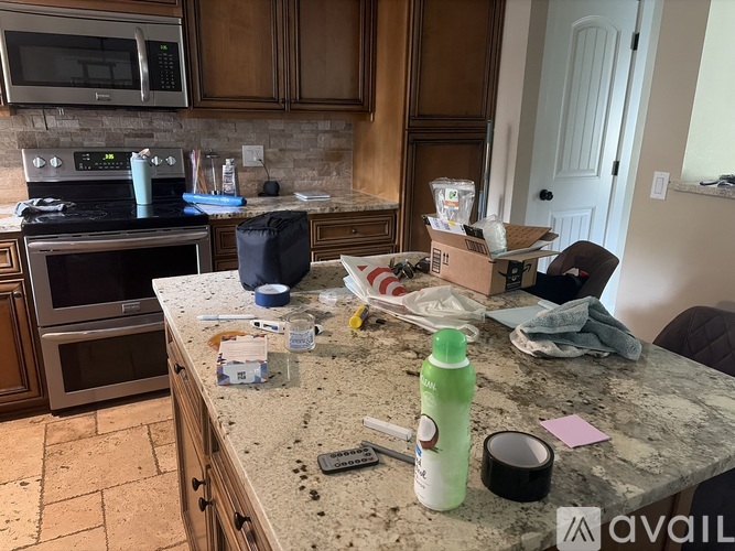 A kitchen counter with a lot of items on it.