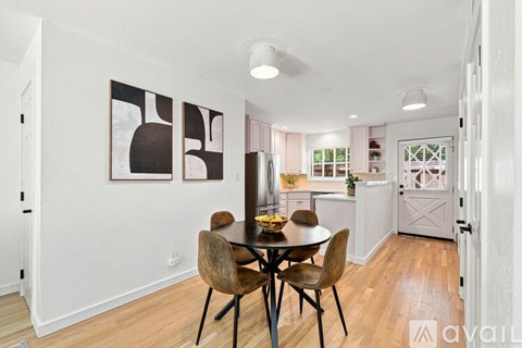 A dining room with a table and chairs.