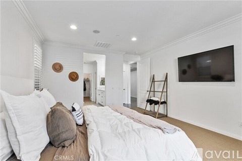 A bedroom with a large bed and a painting on the wall.
