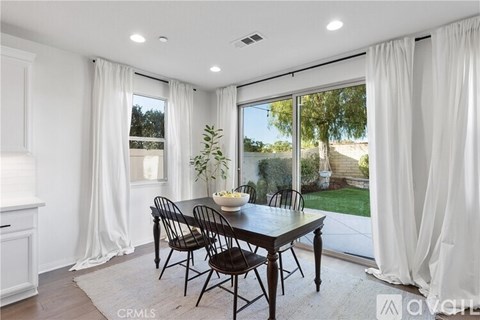 A dining room with a table set for four.