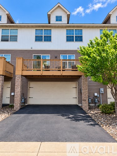 A two-story building with a balcony and garage.