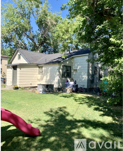 A house with a red slide in the yard.