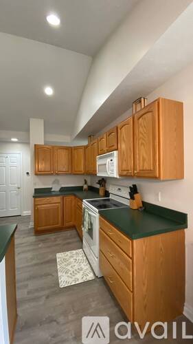 A kitchen with wooden cabinets and a green countertop.