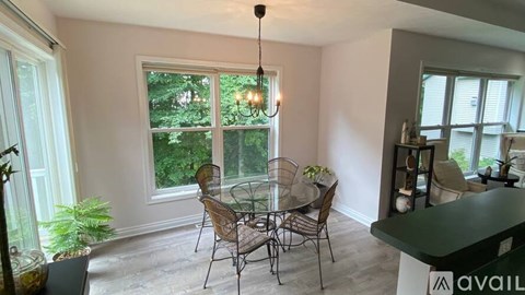 A dining room with a glass table and chairs.