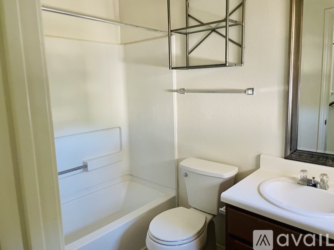 A white toilet sits next to a sink in a small bathroom.