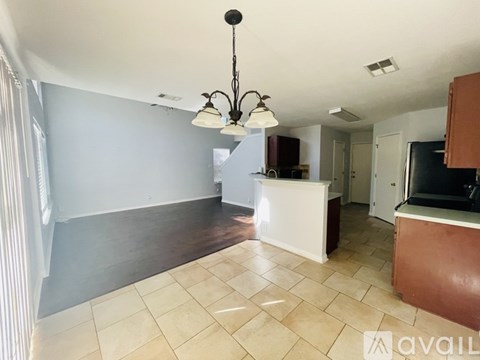 A kitchen area with a white counter and a brown cabinet.