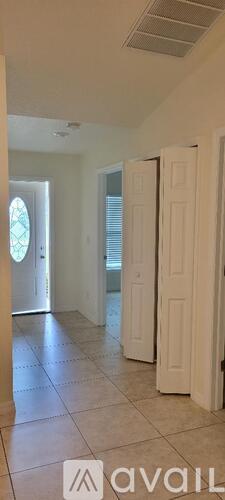 A room with white walls and a tiled floor.