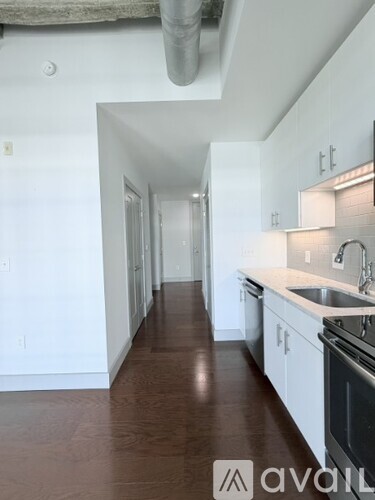 A long hallway with a kitchen on the right side.