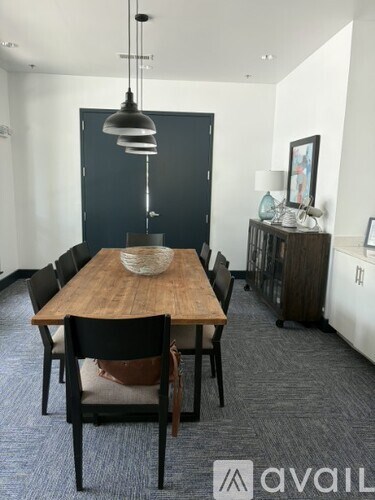 A dining room with a wooden table and chairs.