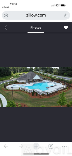A swimming pool surrounded by a grassy area.