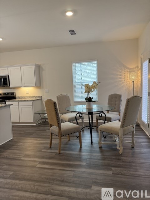 A dining room with a table set for four.
