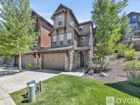 A house with a brown and beige exterior is for sale.