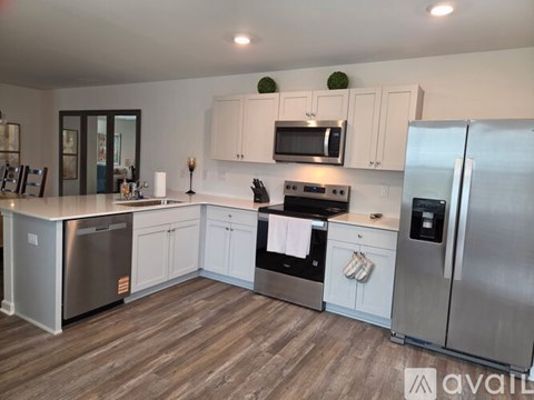 A kitchen with white cabinets and stainless steel appliances.