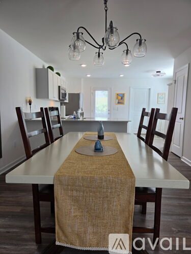 A dining room with a table set for four.