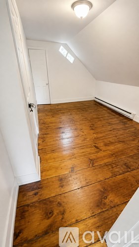A room with wooden floors and white walls.