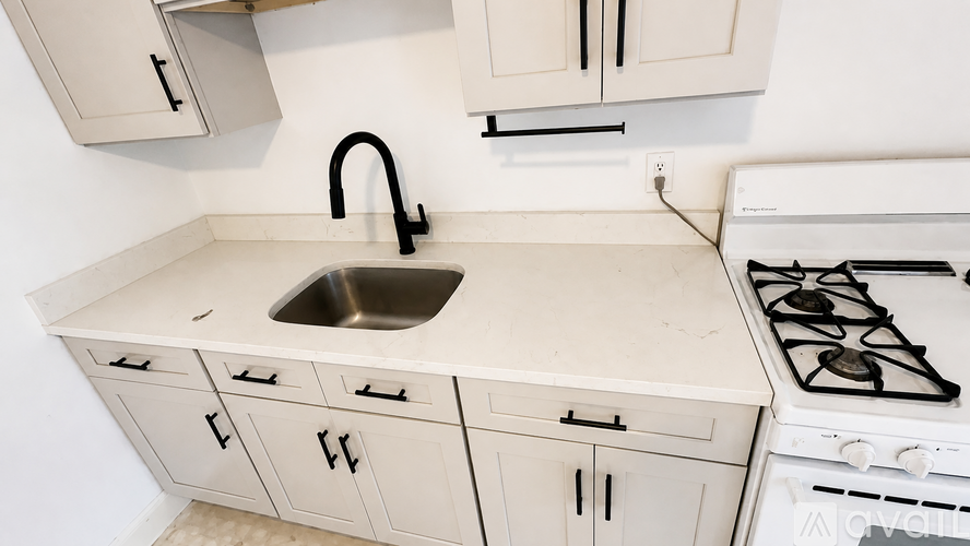 A kitchen with a white stove and a sink.