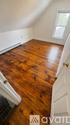 A room with wooden floors and a window.