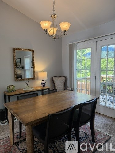 A dining room with a wooden table and chairs.