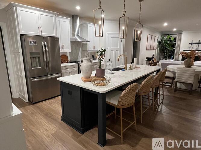 A kitchen with a large island and modern appliances.