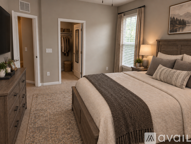 A bedroom with a large bed and a television.