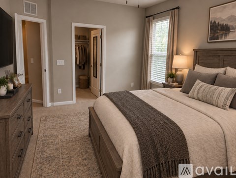 A bedroom with a large bed and a television.