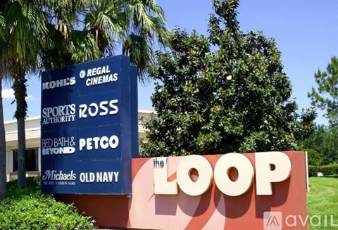 A sign for The Loop is displayed in front of a building.