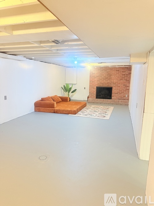 A living room with a couch and a fireplace.