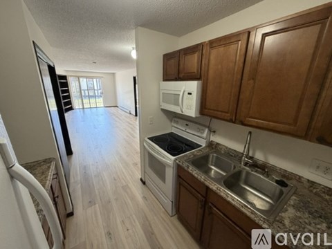 A kitchen with wooden cabinets and a stove top oven.