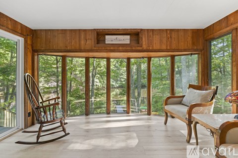 A living room with a rocking chair and a couch.