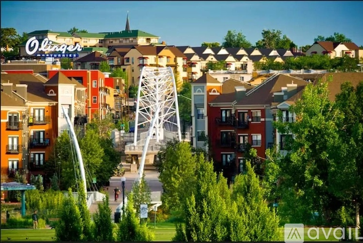 A cityscape with a large white tower in the middle of the buildings.