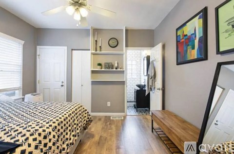 A bedroom with a bed, dresser, and mirror.