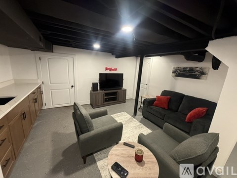 A living room with a grey couch and a television.