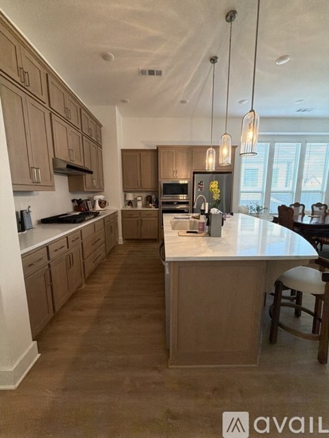 A kitchen with brown cabinets and a white island.