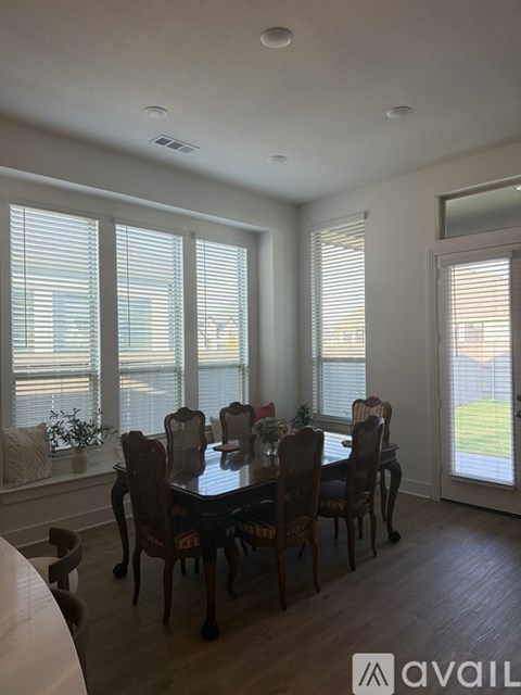 A dining room with a table set for six.