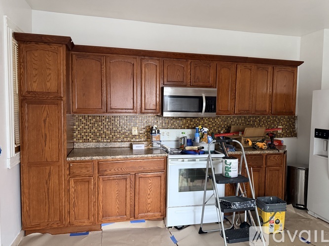 A kitchen with wooden cabinets and a white oven.