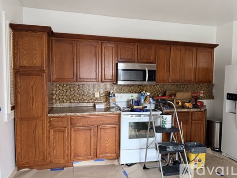 A kitchen with wooden cabinets and a white oven.