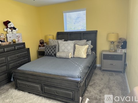 A bedroom with a bed, dresser, and nightstand.