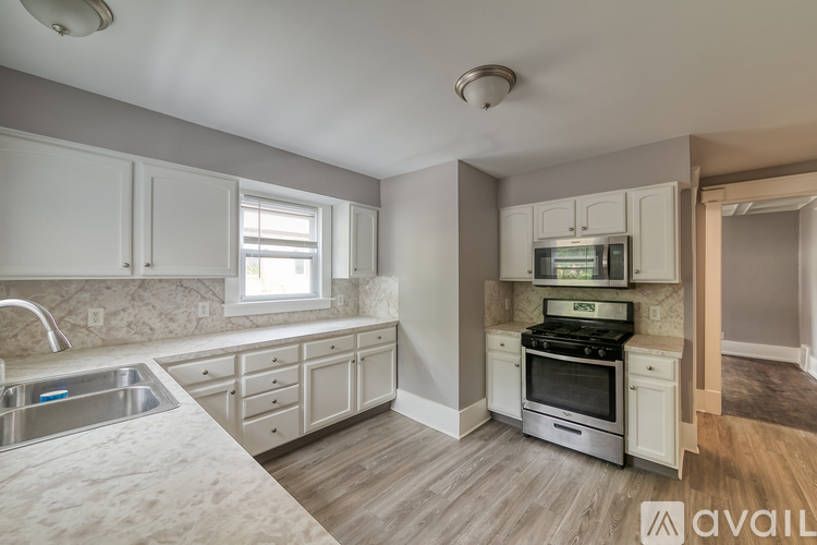 A kitchen with a stove and sink.
