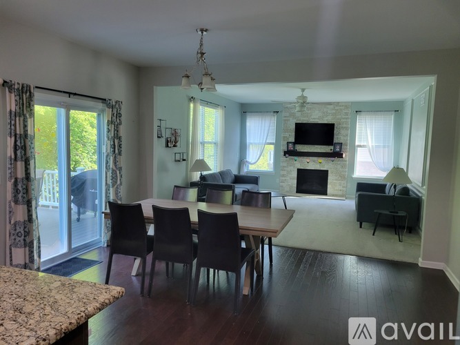 A living room with a dining table and chairs.