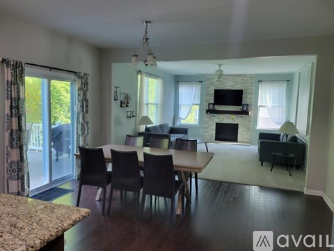 A living room with a dining table and chairs.