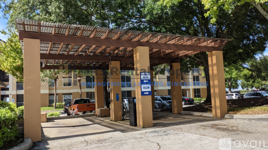 A covered walkway leads to a building with a sign that reads "Management.".