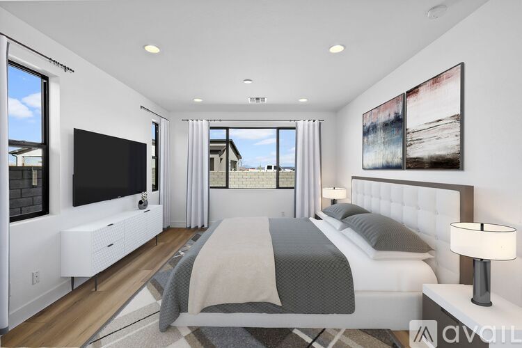 A modern bedroom with a large bed and a flat screen TV.