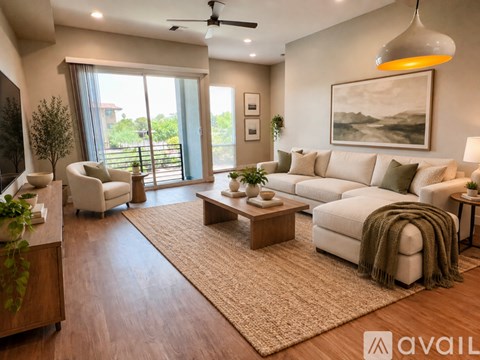 A living room with a white couch, a rug, and a painting on the wall.